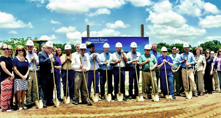 Central Texas Farm Credit team stands with shovels